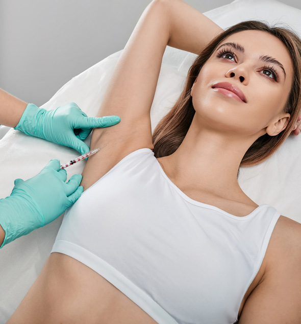 woman receiving injection in armpit during medical procedure for skin enhancement and beauty 4 treatments