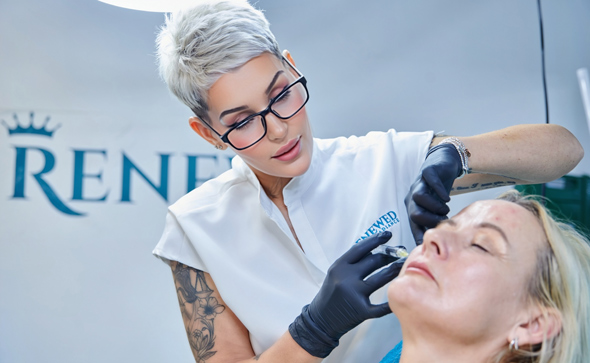 aesthetic professional administering treatment to client in a beauty clinic focused on skin rejuvenation and enhancement techniques