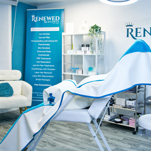 interior of a beauty clinic with treatment chair and promotional banners featuring advanced aesthetic services for skin rejuvenation and beauty