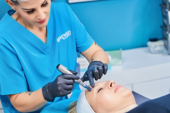 professional skincare treatment with microneedling techniques being applied to a client's face in a modern clinic setting